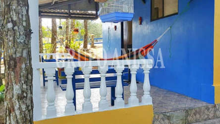 Covered porch with hammock, seating, blue and yellow walls Altos del Cerro Azul Panama