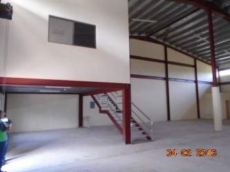 Mezzanine office area inside industrial warehouse with metal staircase in Bugaba Panama