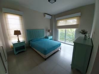 Bright open plan living dining area with panoramic ocean view in Casamar Resort