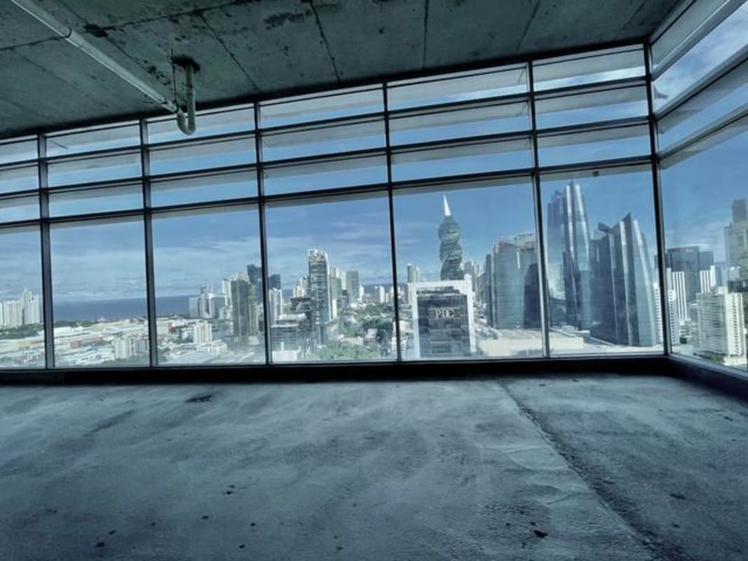 Unfinished open commercial floor with floor-to-ceiling windows and city views at Sortis Tower Panama