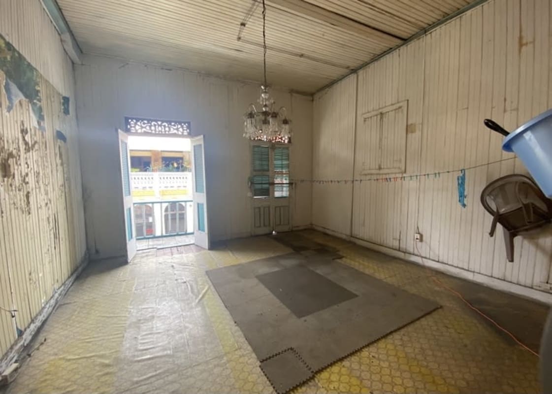 Vintage interior with wood paneling, high ceiling, old chandelier in Casco Viejo Panama townhouse