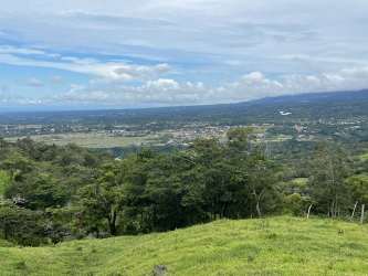 Hilltop green land overlooking valley and distant mountains in Boquete Panama