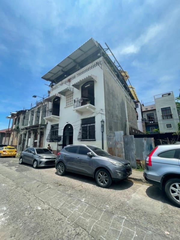 Corner colonial style building with balconies and arched doorways in Santa Ana neighborhood Casco Viejo Panama
