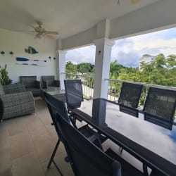 Covered terrace with dining and lounge furniture at Bijao Miraflores Panama beachfront condo rental