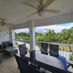 Large terrace balcony with dining and lounge furniture in beach condo at Bijao Miraflores Panama