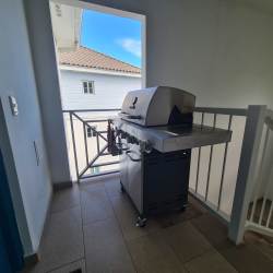 Private balcony terrace with barbecue grill and lush scenery at Bijao Miraflores beachfront apartment for rent