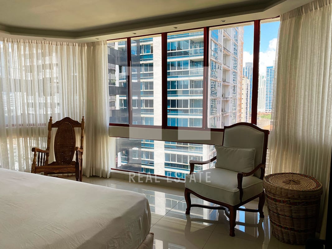 Living room with red sectional sofa, built-in bar and AC, apartment in Twin Towers Marbella Panama