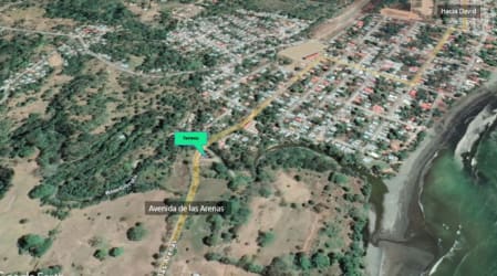 Aerial photo of coastal Puerto Armuelles town, ocean coastline, Avenida de las Arenas main road, green areas Chiriquí Panama