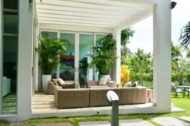 Bedroom with multiple beds and tropical decor Punta Chame beachfront villa rental