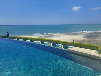 Living and dining space with oceanfront view balcony Riomar Resort Panama