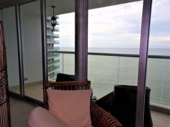 Living room with ocean views, balcony access and open layout at Bahia Resort Nueva Gorgona