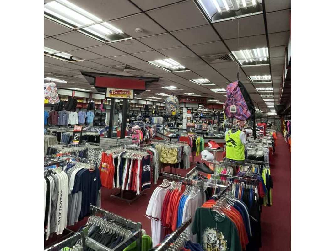 Interior of retail clothing store with racks Panama City for sale