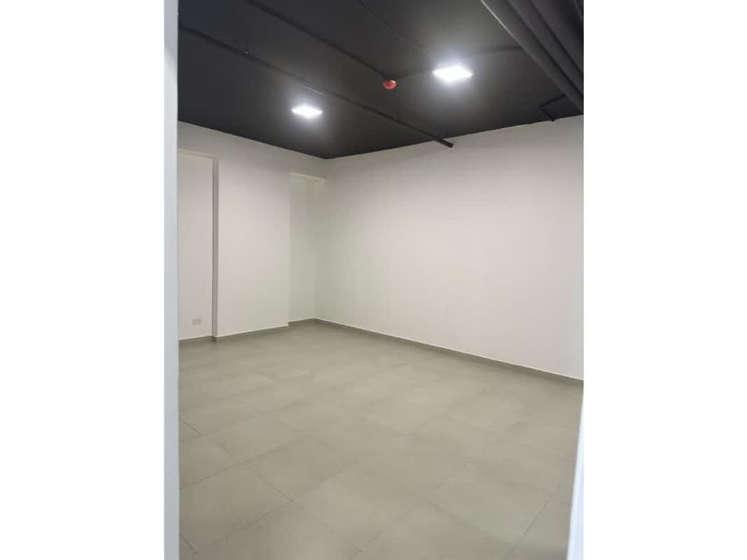 Empty minimalist office room with black ceiling and tiled floor in Panama City