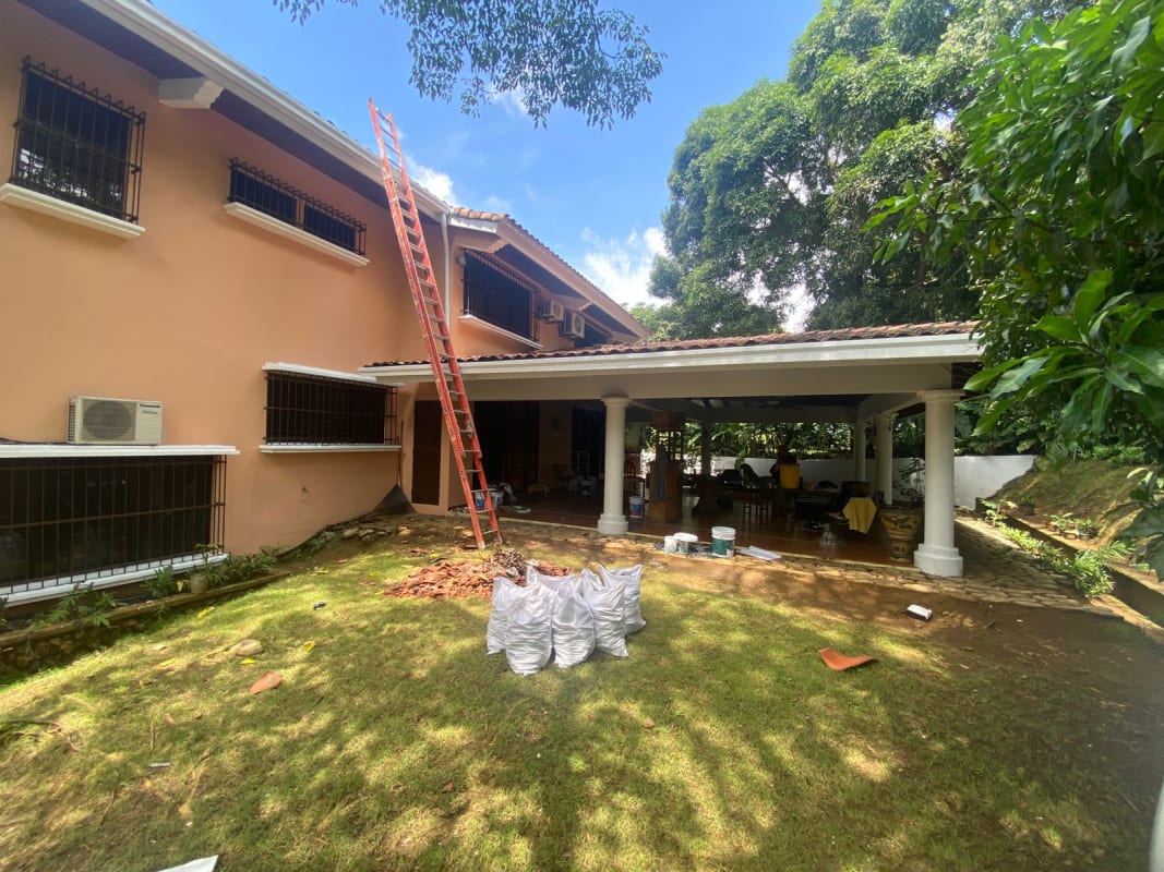 Peach-colored two-story Mediterranean house with patio and garden on development lot La Loma Panama