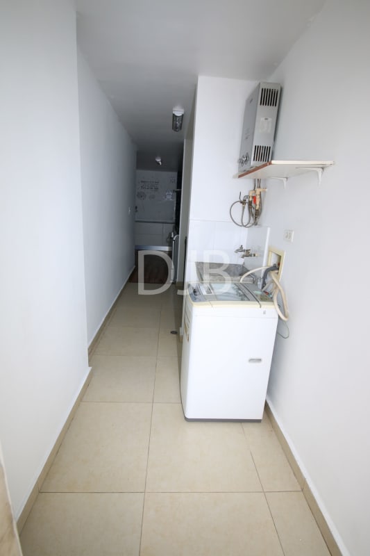 Laundry room featuring washer and gas heater at PH Torres del Parque Panama