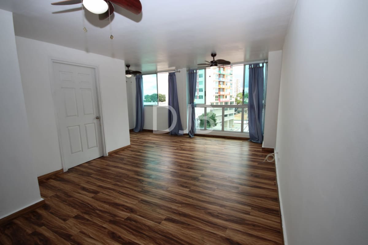 Bright living dining area with terrace access, ceiling fans and modern floors in Torres del Parque Panama