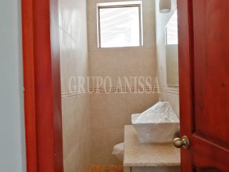 Bedroom with private bathroom, large window, and closet in Altos del María Panama luxury home