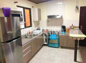 Living room with large sliding doors opening to balcony mountain cabin Altos del María Panama