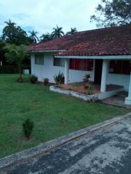 Traditional single story home with red roof tiles, front porch, ample yard in Howard residential zone Panama