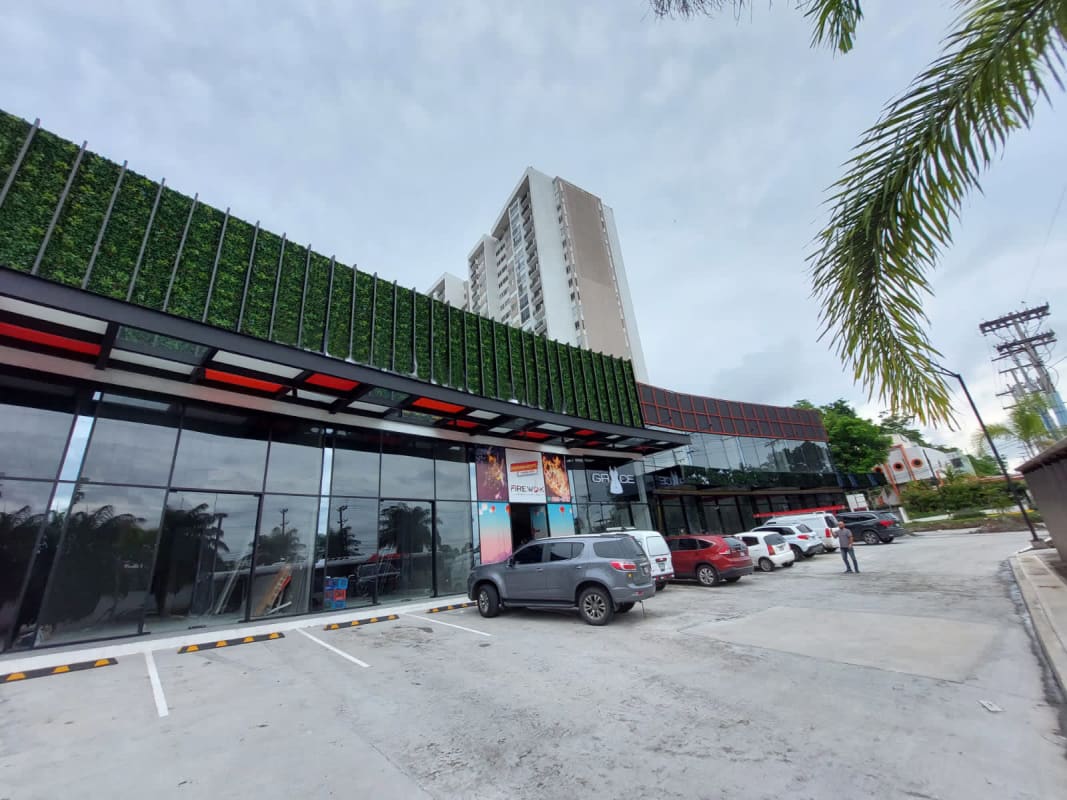 View of upper mezzanine with stainless steel railing and tiled floors at Plaza Midtown commercial space Panama