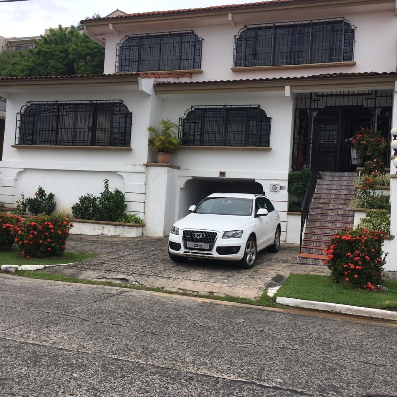 One-story building with blue fence and Panama skyline background