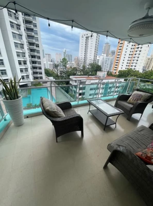 Large living room with wood floors and balcony access in PH Crystal Panama City