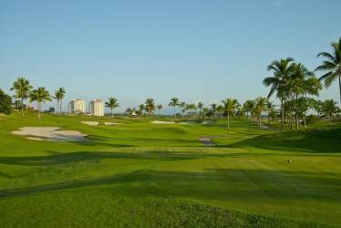Lush green golf course with palm trees in Vista Mar Resort Panama