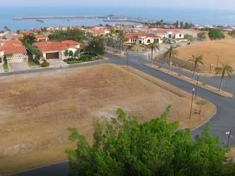 Aerial with vacant lot in coastal neighborhood near ocean Vista Mar Panama