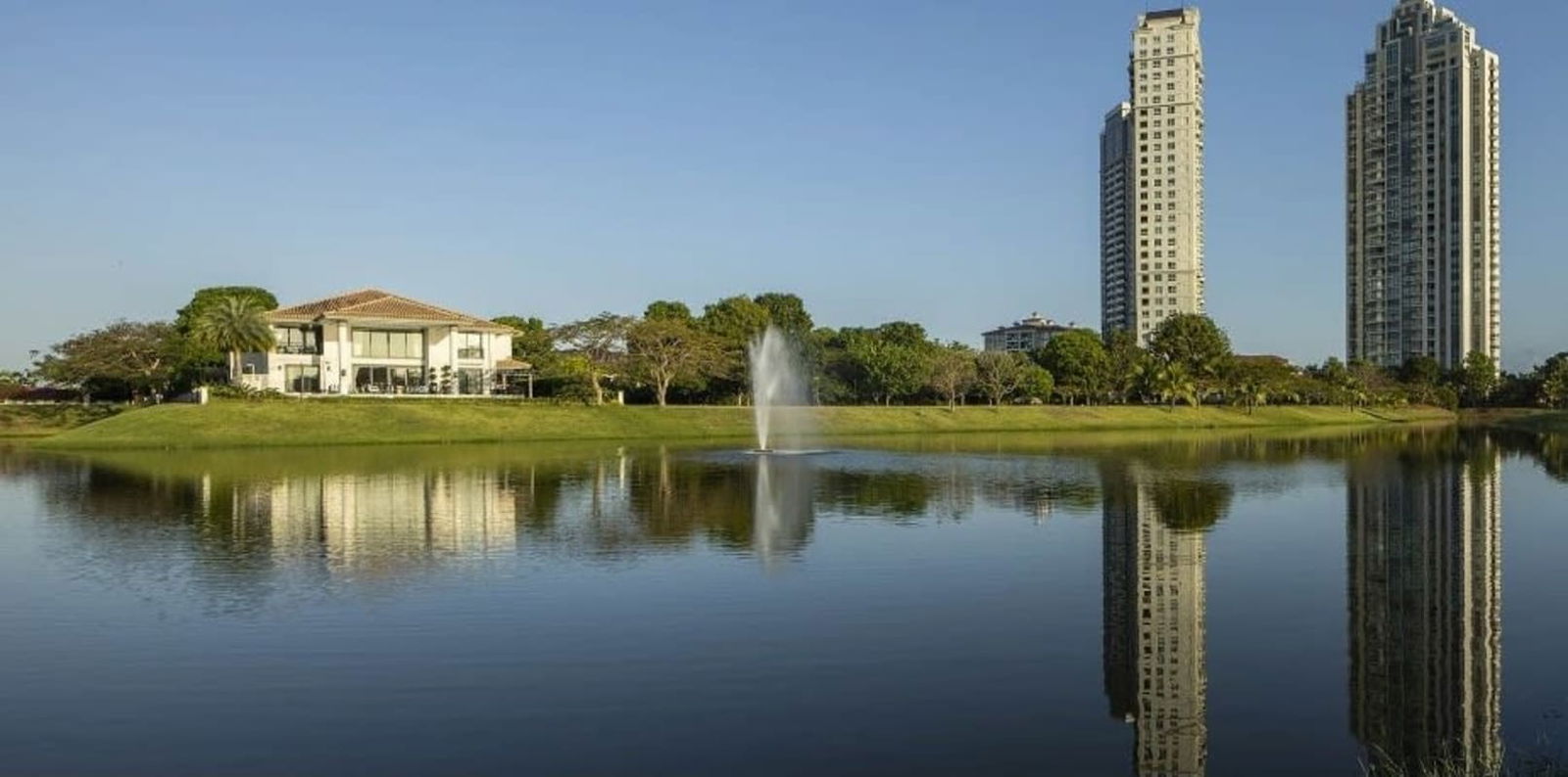 Lakeside houses with high-rise condos in background in Santa María Golf Panama