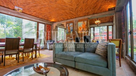 Rustic living and dining with wood ceiling and garden views in mountain estate Altos del María Panama