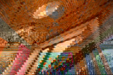 Bright sunroom with exposed brick, panoramic windows overlooking gardens in Altos del María Panama