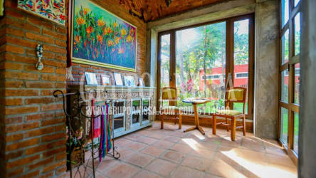 Rustic dining area with large windows overlooking tropical gardens Altos del María Panama