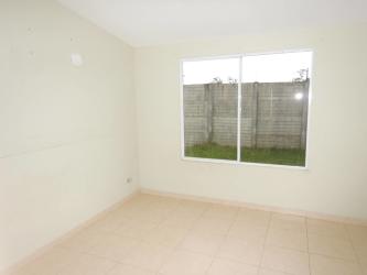 Main bedroom with large window, tile floor, attached walk-in closet Residencial La Arboleda