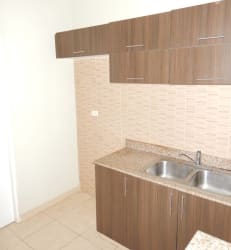 Modern kitchen granite countertops wooden cabinets tile floor Los Cedros Panama