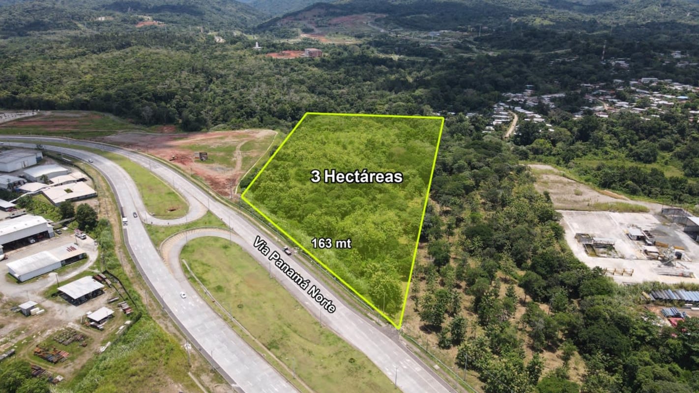 Aerial image showing highway cloverleaf, nearby industrial buildings, hills and 3 hectares land lot for sale Panama Norte