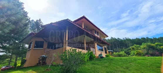 Exterior of two-story mountain house with balconies in Altos del María Panama