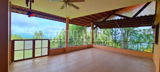 Covered terrace with rustic beams and panoramic mountain and ocean views in Altos del María Panama
