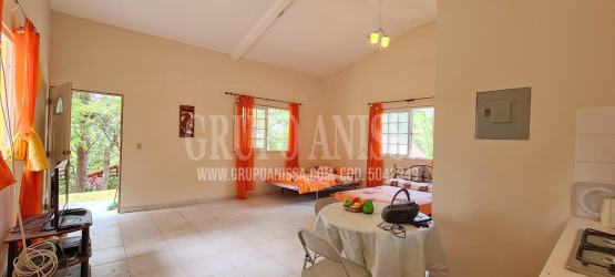 Traditional tiled bathroom with pedestal sink toilet and shower in Altos del María mountain cabin Panama