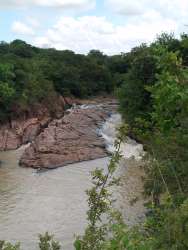 River with rocks and dense forest lining both banks at La Pintada Penonomé