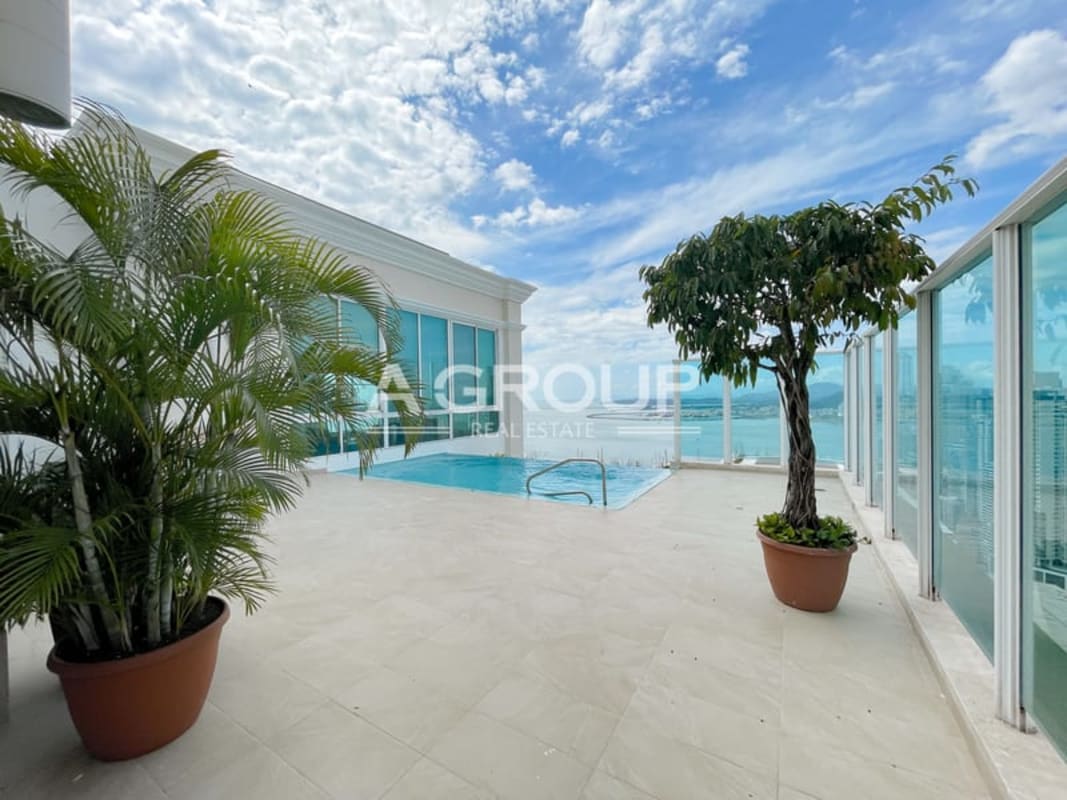 Luxurious marble-clad bathroom with bathtub, chandelier, and ocean view window PH Aquamarina Punta Pacifica Panama