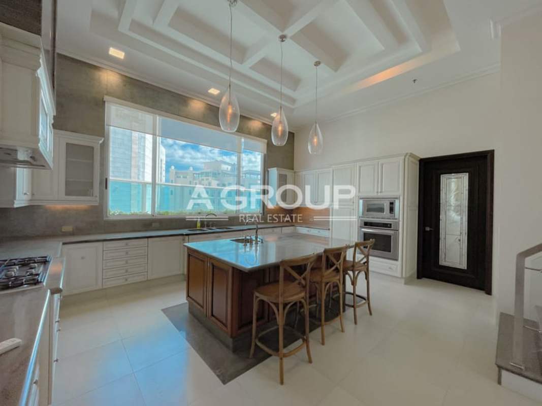 Formal dining area with tray ceiling, dark cabinetry, marble floors luxury penthouse Panama