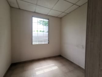 Side exterior of single-story house with garden and concrete fence in Arraiján Panama