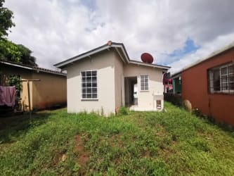 Suburban street with parked pickups and houses in Altos del Tecal Arraiján Panama
