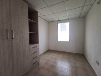 Minimalist bedroom with wardrobe and natural light in affordable house for sale in Arraiján