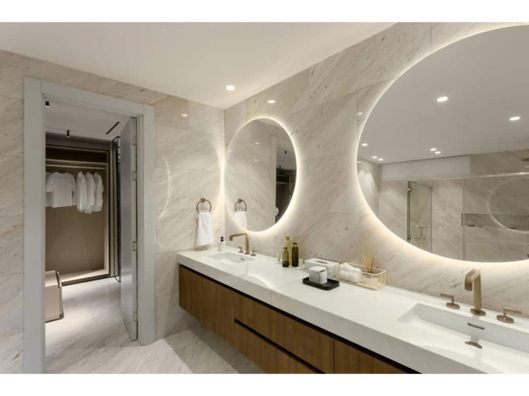 Modern minimalist living room with built-in desk and mounted TV in The Towers Panama