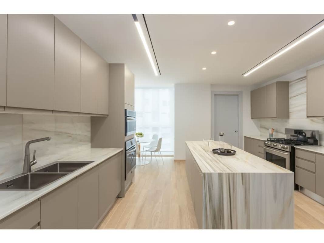 Luxury apartment kitchen with marble island, modern appliances in The Towers Panama