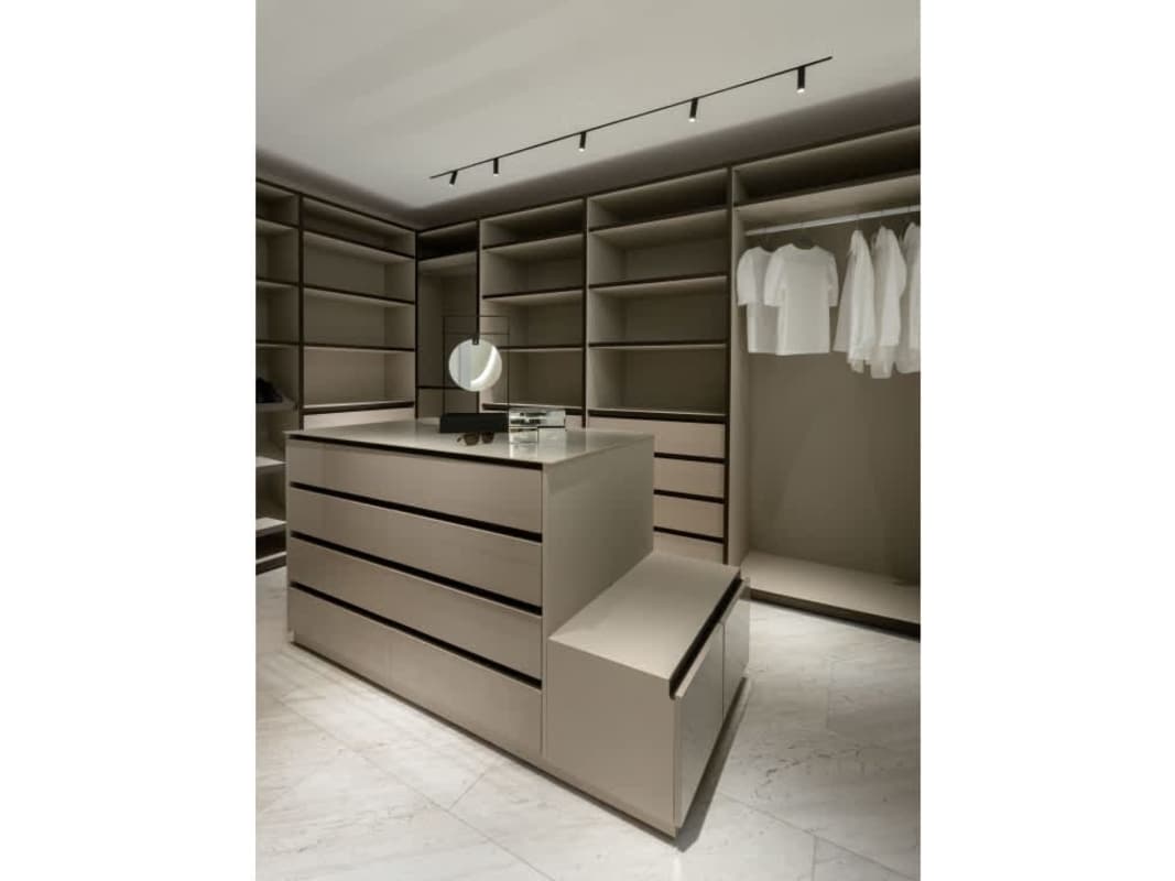 Spacious walk-in closet with center island and custom shelving at The Towers luxury apartment Panama