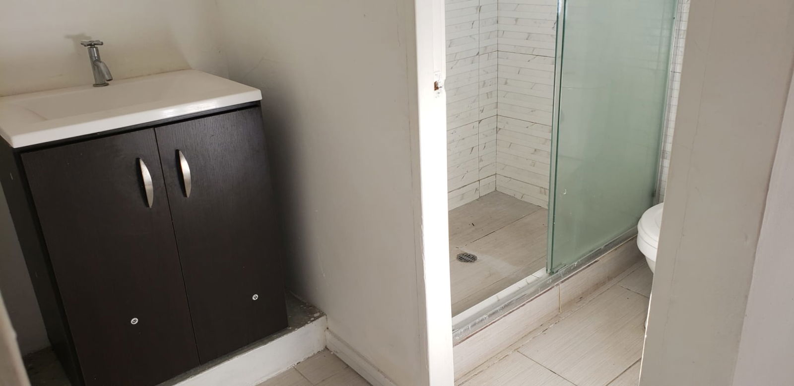 Bathroom with walk-in glass shower, tile flooring and vanity Altos de San Angel