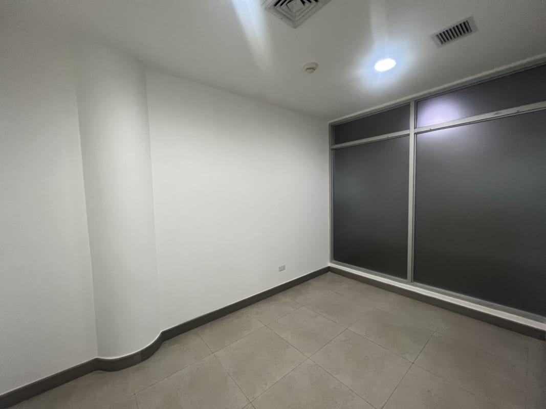 Open-plan workspace with tile floor and recessed lighting at BMW Center Costa del Este Panama