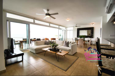 Open concept living room with panoramic ocean view balcony Miramar Loft Playa Farallon Panama rental